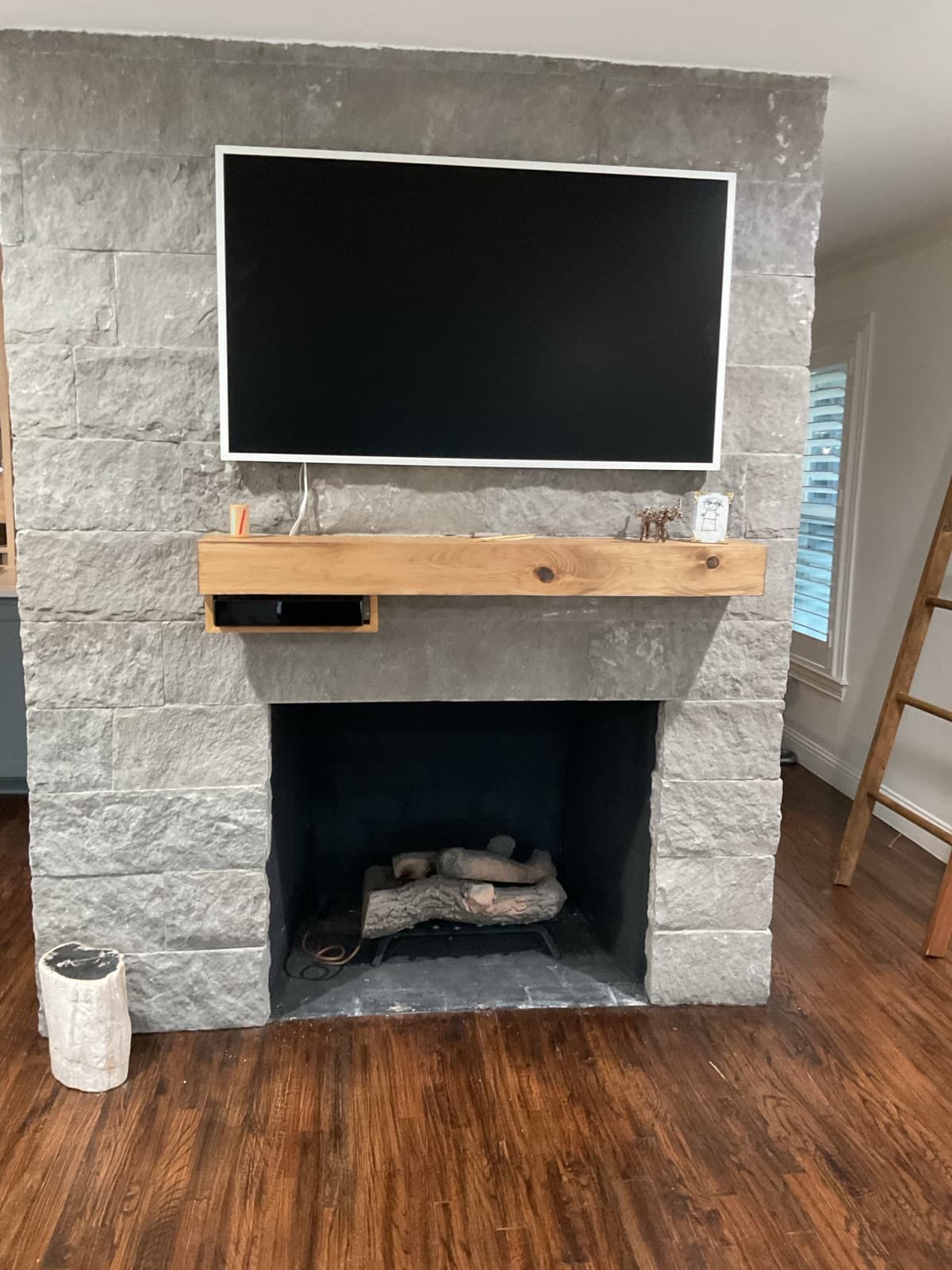 TV mounted above stone fireplace